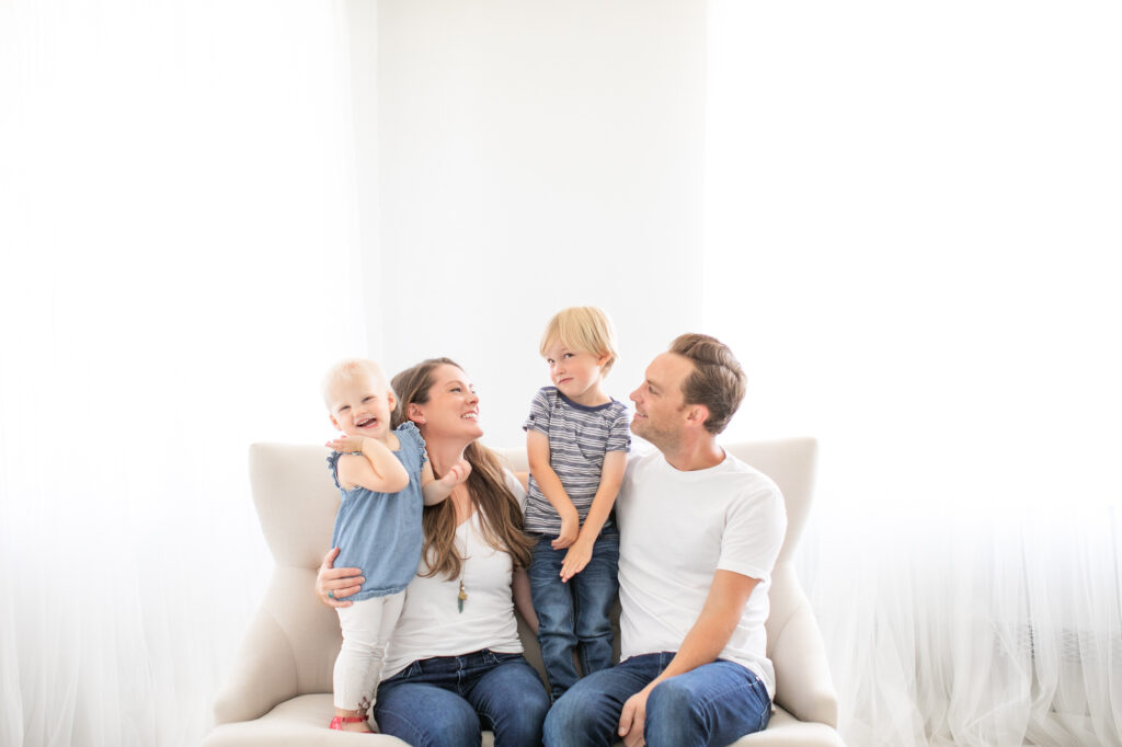 A family of 4 at the photography studio of Tiffany Hix Photography.