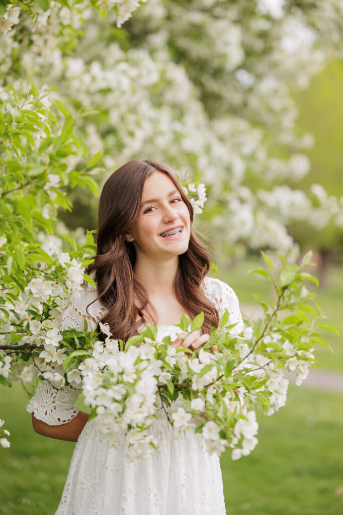 Girl standing in a blooming tree in Boise.
