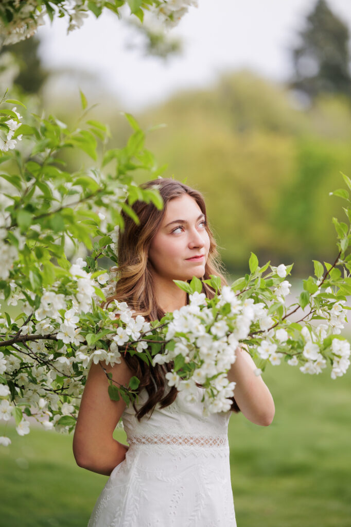 Girl standing in a blooming tree in Boise.