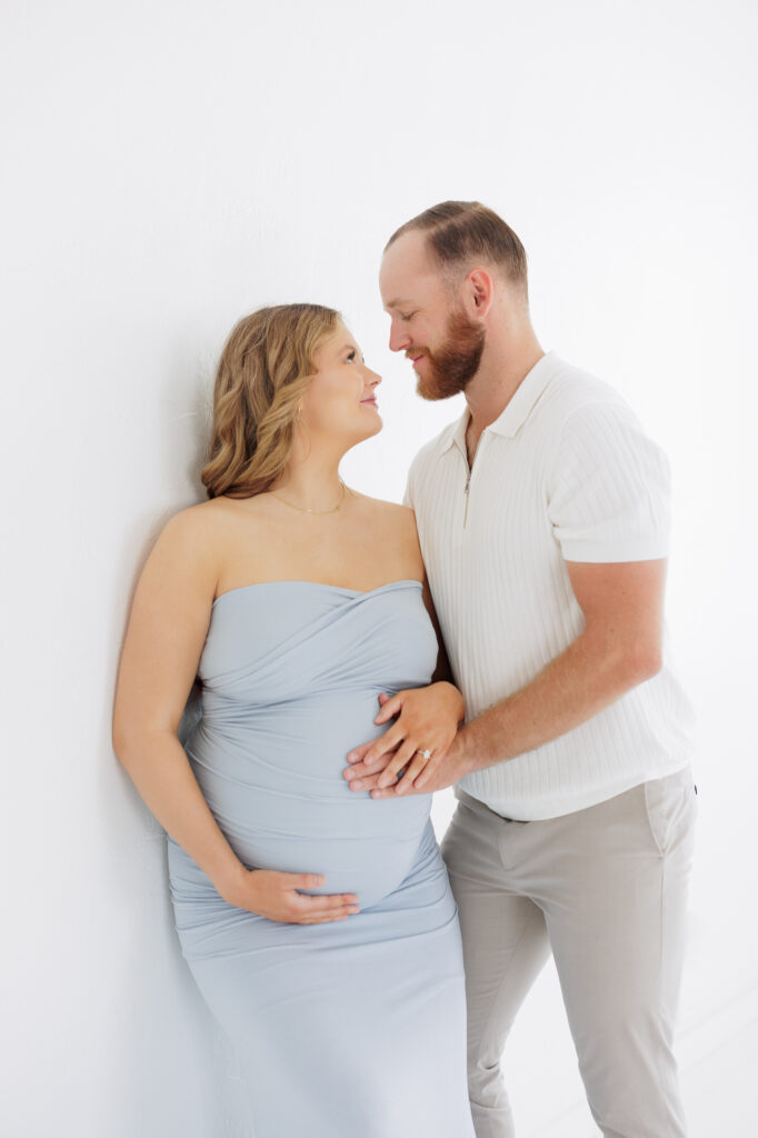 First grand baby maternity portraits in Boise studio with couple embracing