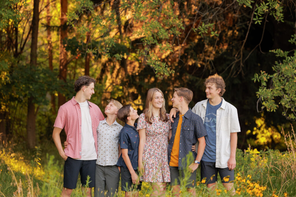 A family of six siblings standing at Kathryn Alberston Park during the summer.