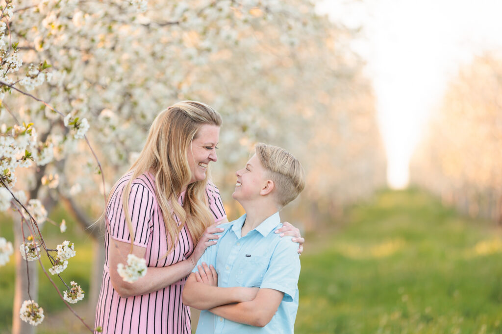A mom and son laughing at each other during spring family photos in Boise.